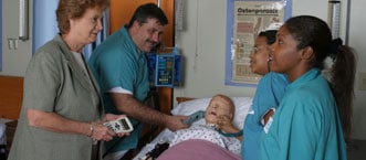 nursing students listening to nurse instructor