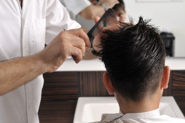 Barber student cutting hair