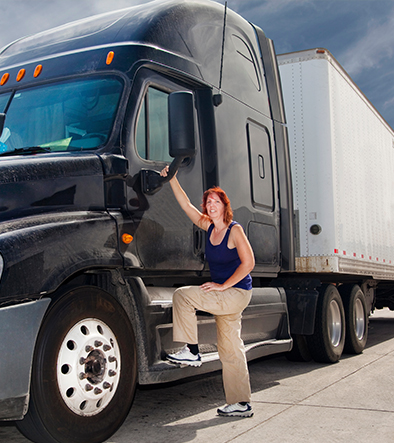 female truck driver stepping up on truck step