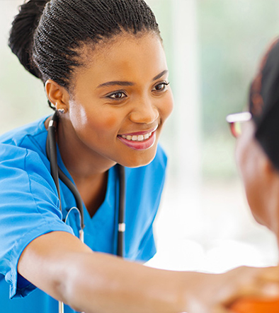 Patient Care Technician smiling at a patient