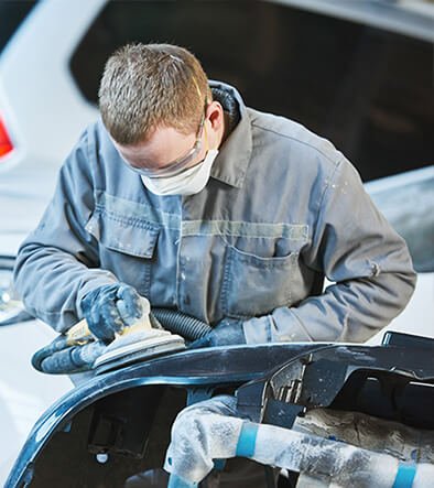 automotive collision technician buffing a car