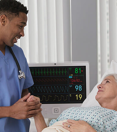 Electrocardiograph Technician holding patients hand