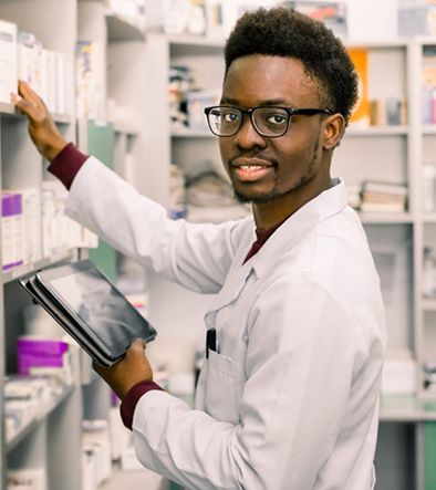 smiling pharmacy technician sorting medicines