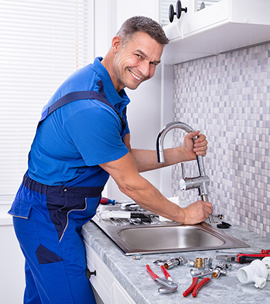 Plumber installing a faucet