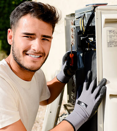 Heating technician repairing a AC unit